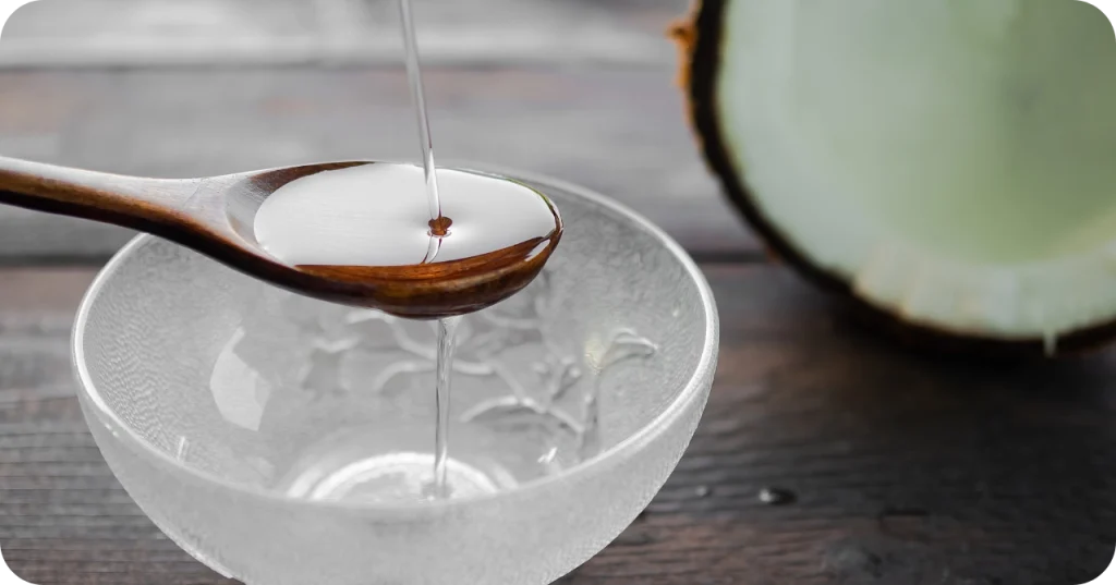 Hand demonstrating the lightweight texture of Realsa Virgin Coconut Oil for skincare applications, exported from Indonesia