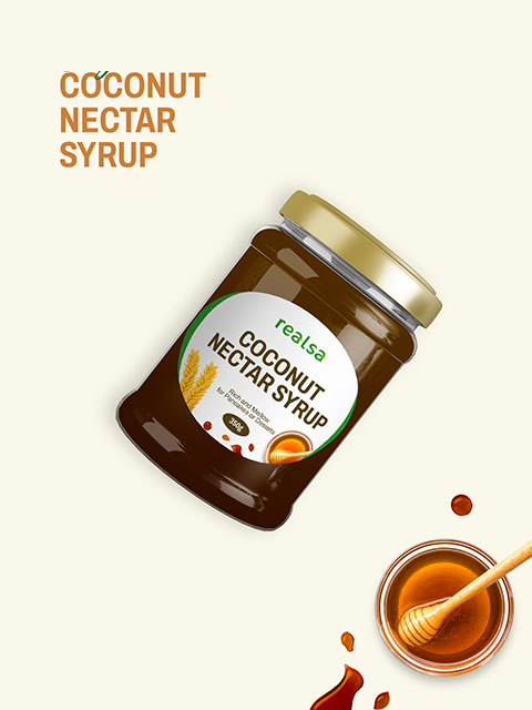 A jar of Realsa Coconut Nectar Syrup with golden lid, shown beside a bowl of syrup and honey dipper.